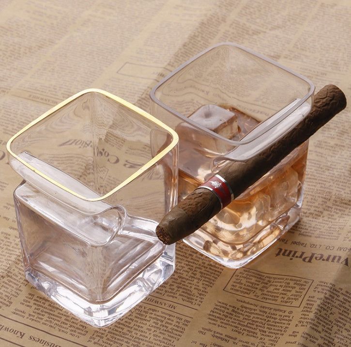 Two cigar glasses with whiskey and cigars