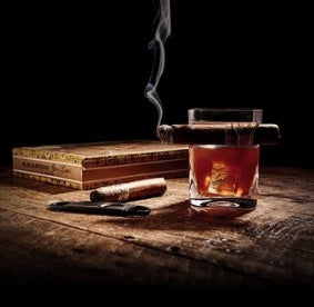 Cigar glass with whiskey and cigar on wooden table